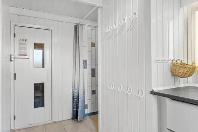 a bathroom with white walls and a door and a counter at BL1486-Saltum-Ornebjergvej-4 in Saltum
