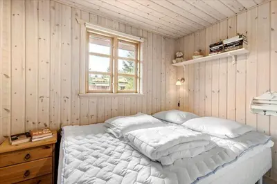 a bedroom with a white bed with a window at BL1743-Pandrup-Rodhus-Skolevej-14 in Pandrup