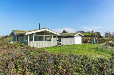 a house with a yard with a swing at BL1448-Pandrup-Hunetorp-Klitvej-215 in Pandrup