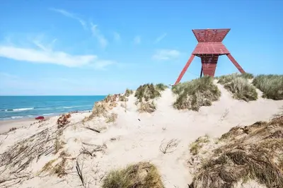 a wooden structure on top of a sandy beach at BL1471-Blokhus-Solbakkevej-15 in Blokhus