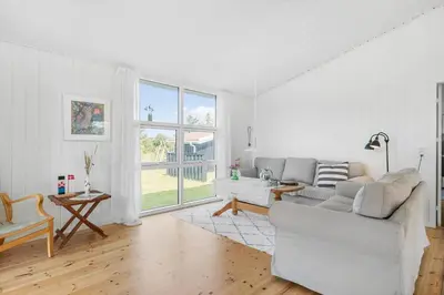 a white living room with a couch and a table at BL1471-Blokhus-Solbakkevej-15 in Blokhus