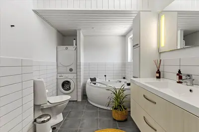 a bathroom with a sink toilet and a washing machine at BL479-Saltum-Laustvej-26 in Saltum