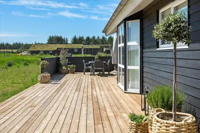 a wooden deck on the side of a house at BL479-Saltum-Laustvej-26 in Saltum