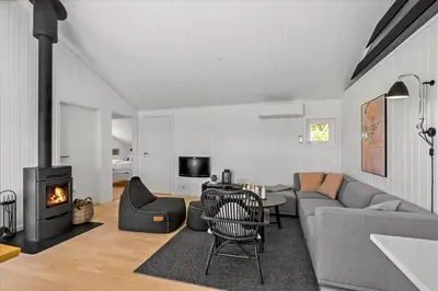 a living room with a couch and a fireplace at BL479-Saltum-Laustvej-26 in Saltum