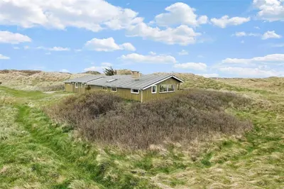 a house on top of a hill in a field at BL612-Pandrup-Sydvej-10 in Pandrup
