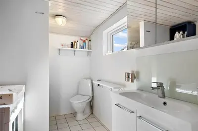a white bathroom with a toilet and a sink at BL612-Pandrup-Sydvej-10 in Pandrup