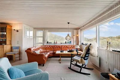 a living room with a leather couch and a table at BL612-Pandrup-Sydvej-10 in Pandrup