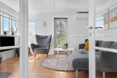 a living room with a couch and chairs and a table at BL1550-Blokhus-Poppelvej-10 in Blokhus