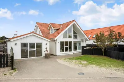 a white house with an orange roof at BL1567-Blokhus-Klitvejen-6 in Blokhus