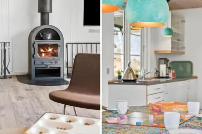 a kitchen and a living room with a stove at BL1639-Blokhus-Bloksbjerg-57 in Blokhus