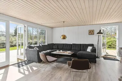 a living room with a couch and a table at BL1639-Blokhus-Bloksbjerg-57 in Blokhus