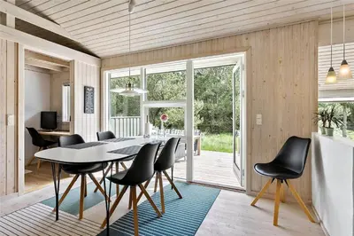 a dining room with a table and black chairs at BL1725-Saltum-Sonderborgvej-17 in Saltum
