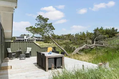 a patio with a table and chairs and a tree at BL1725-Saltum-Sonderborgvej-17 in Saltum