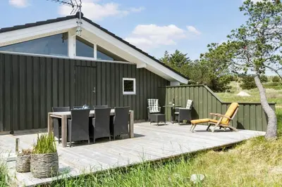 a deck with a table and chairs on a house at BL1725-Saltum-Sonderborgvej-17 in Saltum