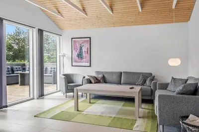 a living room with a couch and a coffee table at BL1236-Pandrup-Kirkekrogen-5 in Pandrup