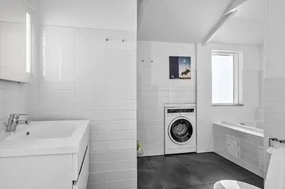 a white bathroom with a washing machine in it at BL1236-Pandrup-Kirkekrogen-5 in Pandrup