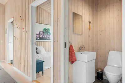 a bathroom with a toilet and a sink and a bed at BL448-Saltum-Nordvestvej-1 in Saltum