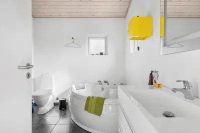 a white bathroom with a tub and a toilet at BL448-Saltum-Nordvestvej-1 in Saltum