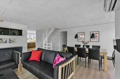a living room with a black couch and a table at BL854-Saltum-Porsevej-6-A in Saltum