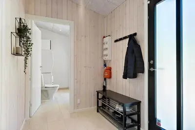 a bathroom with a toilet and a black table at BL1565-Blokhus-Plantagevej-2-A in Blokhus