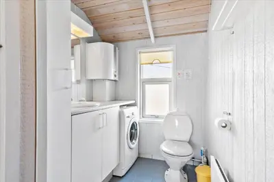 a small bathroom with a toilet and a sink at BL1747-Blokhus-Norresundbyvej-22 in Blokhus