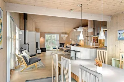a kitchen and living room with wooden walls at BL1233-Saltum-Krogsletten-14 in Saltum