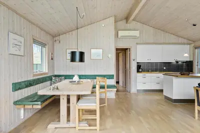 a kitchen and dining room with a table and chairs at BL1522-Saltum-Kordalslien-25 in Saltum