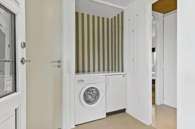 a white laundry room with a washer and dryer at BL1136-Blokhus-Graevlingevej-6 in Blokhus