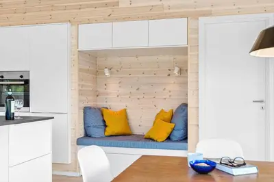 a room with a blue couch with yellow pillows at BL1464-Saltum-Nordvestvej-34 in Saltum