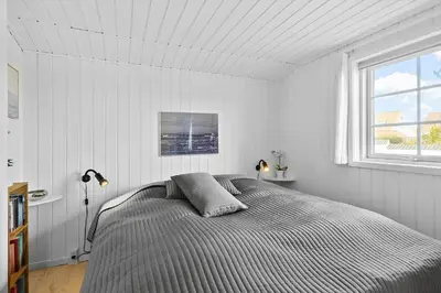 a bedroom with a bed and a window at BL856-Blokhus-Soren-Tjenersvej-2 in Blokhus
