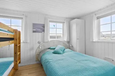 a bedroom with two beds and two windows at BL856-Blokhus-Soren-Tjenersvej-2 in Blokhus