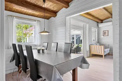 a dining room with a table and chairs at BL141-Blokhus-Vigen-12 in Blokhus