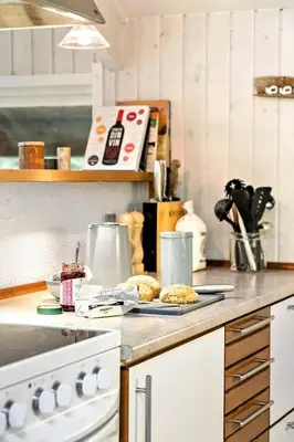 a kitchen counter with cookies on a plate on it at BL353-Blokhus-Kragebak-1 in Blokhus