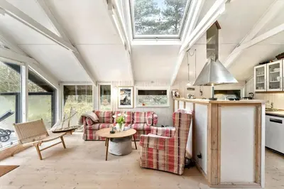 a living room with couches and a table at BL353-Blokhus-Kragebak-1 in Blokhus