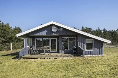 a small house with a porch and a deck at BL1051-Pandrup-Rodhus-Skolevej-11 in Pandrup