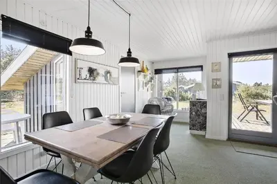 a dining room with a wooden table and chairs at BL1051-Pandrup-Rodhus-Skolevej-11 in Pandrup