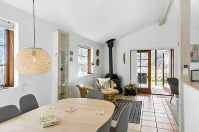 a dining room with a table and chairs in a room at BL245-Pandrup-Bremersvej-4 in Pandrup
