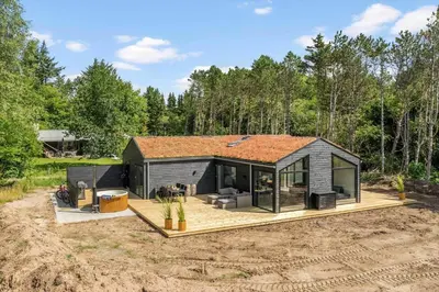 a tiny house in the middle of a field at BL1465-Blokhus-Bag-Hojen-8-c in Blokhus