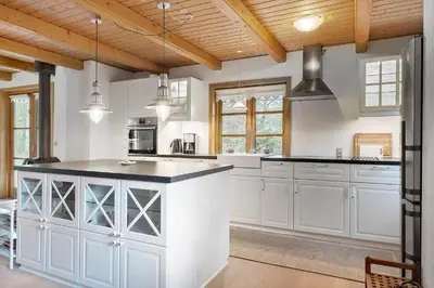 a kitchen with white cabinets and black counter tops at BL1553-Pandrup-Lunekrogen-9 in Pandrup