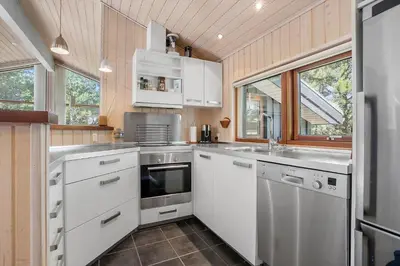 a kitchen with white cabinets and a sink at BL455-Pandrup-Rodhus-Skolevej-52 in Pandrup