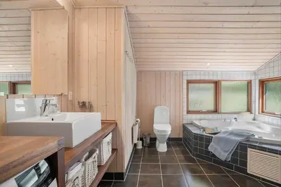 a bathroom with a tub and a sink and a toilet at BL455-Pandrup-Rodhus-Skolevej-52 in Pandrup