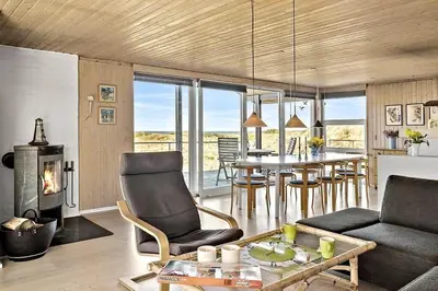 a living room with a table and a dining room at BL678-Saltum-Lemmingvej-10 in Saltum