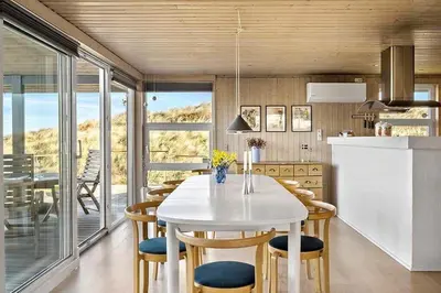 a kitchen with a white table and some chairs at BL678-Saltum-Lemmingvej-10 in Saltum