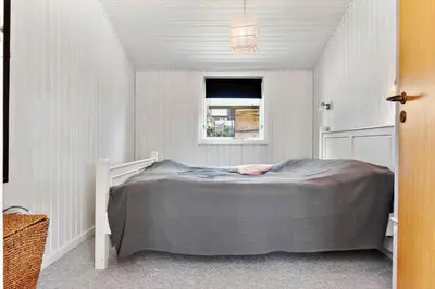a bedroom with a bed in a white room at BL1370-Saltum-Fladen-Grund-14 in Saltum