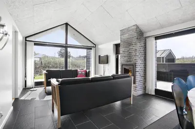 a living room with a couch and a fireplace at BL400-Blokhus-Sdr-Strandvej-9-B in Blokhus