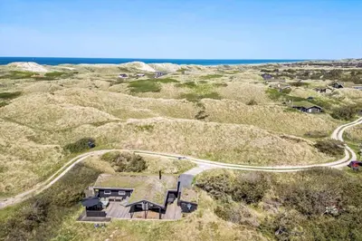 an aerial view of a house on a hill next to the ocean at BL1383-Saltum-Foraarsvangen-18 in Saltum