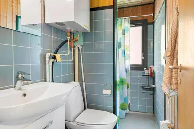 a bathroom with a white sink and a toilet at BL1208-Saltum-Tippen-10 in Saltum
