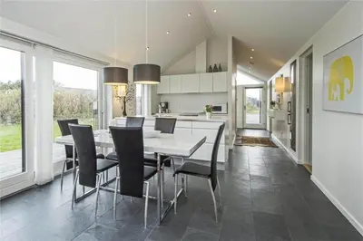 a kitchen and dining room with a table and chairs at BL655-Blokhus-Sdr-Strandvej-11 in Blokhus
