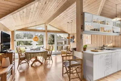 a kitchen and dining room with a table and chairs at BL812-Blokhus-Morten-Nielsensvej-10 in Blokhus