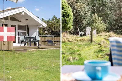 a cup of coffee sitting on a table in front of a house at BL812-Blokhus-Morten-Nielsensvej-10 in Blokhus